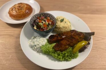 Turkish Adana kebab with coban salatasi, couscous and homemade Turkish mini bread